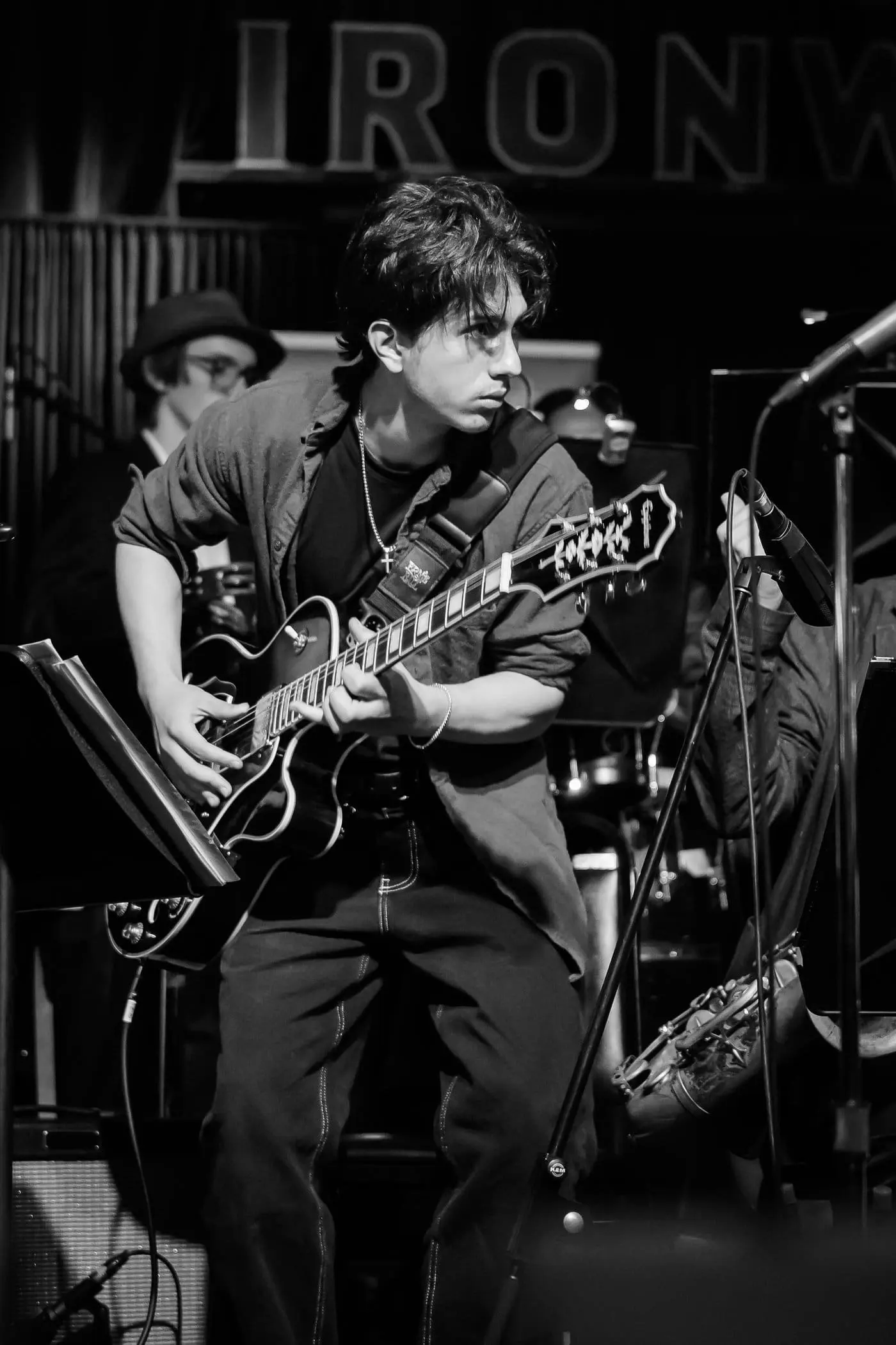 Simon Maxam playing his red cherry acoustic guitar