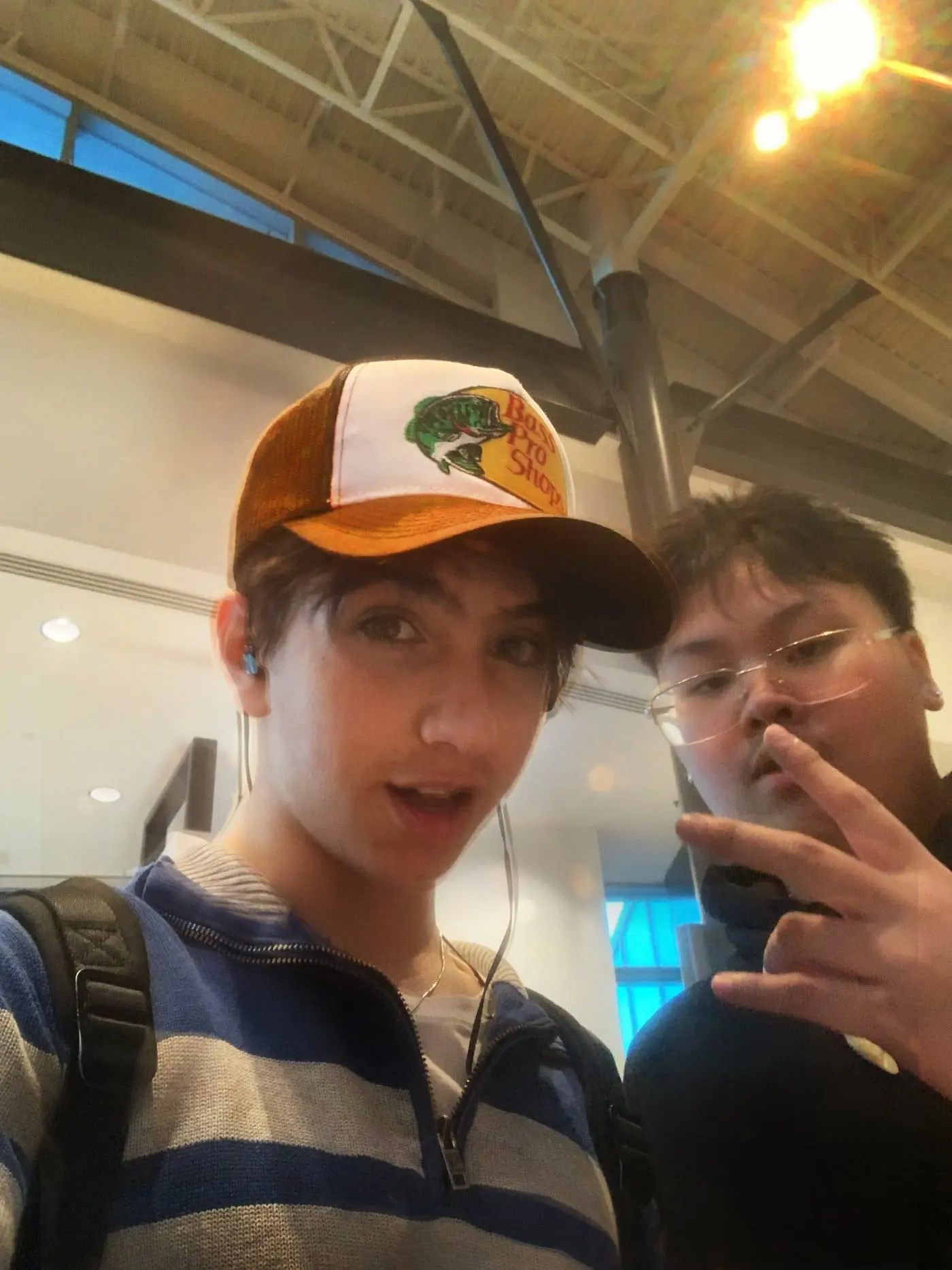 Simon Maxam taking a selfie with a friend inside a shopping mall