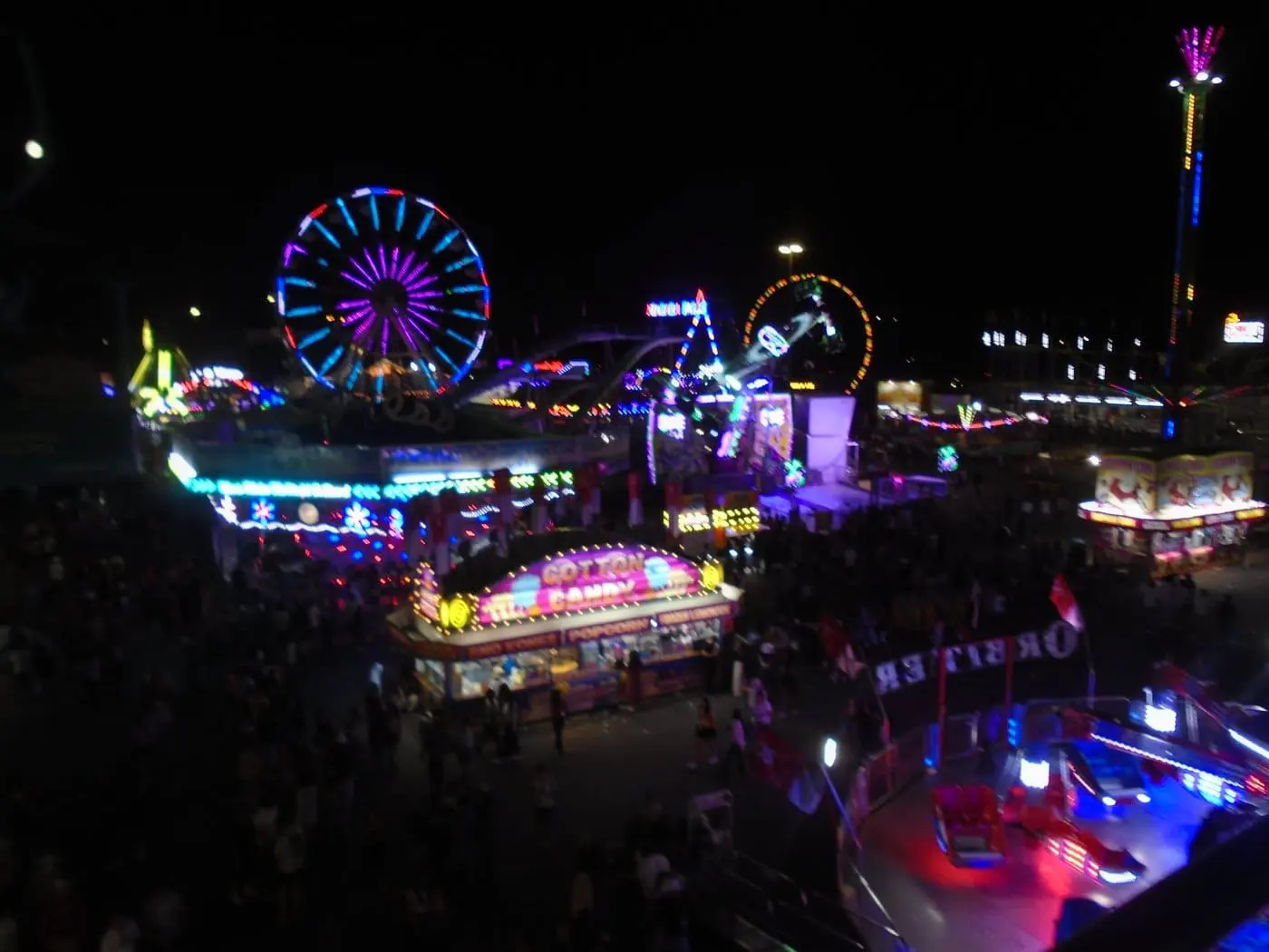 A crowded view of the Calgary Stampede midway from above at night